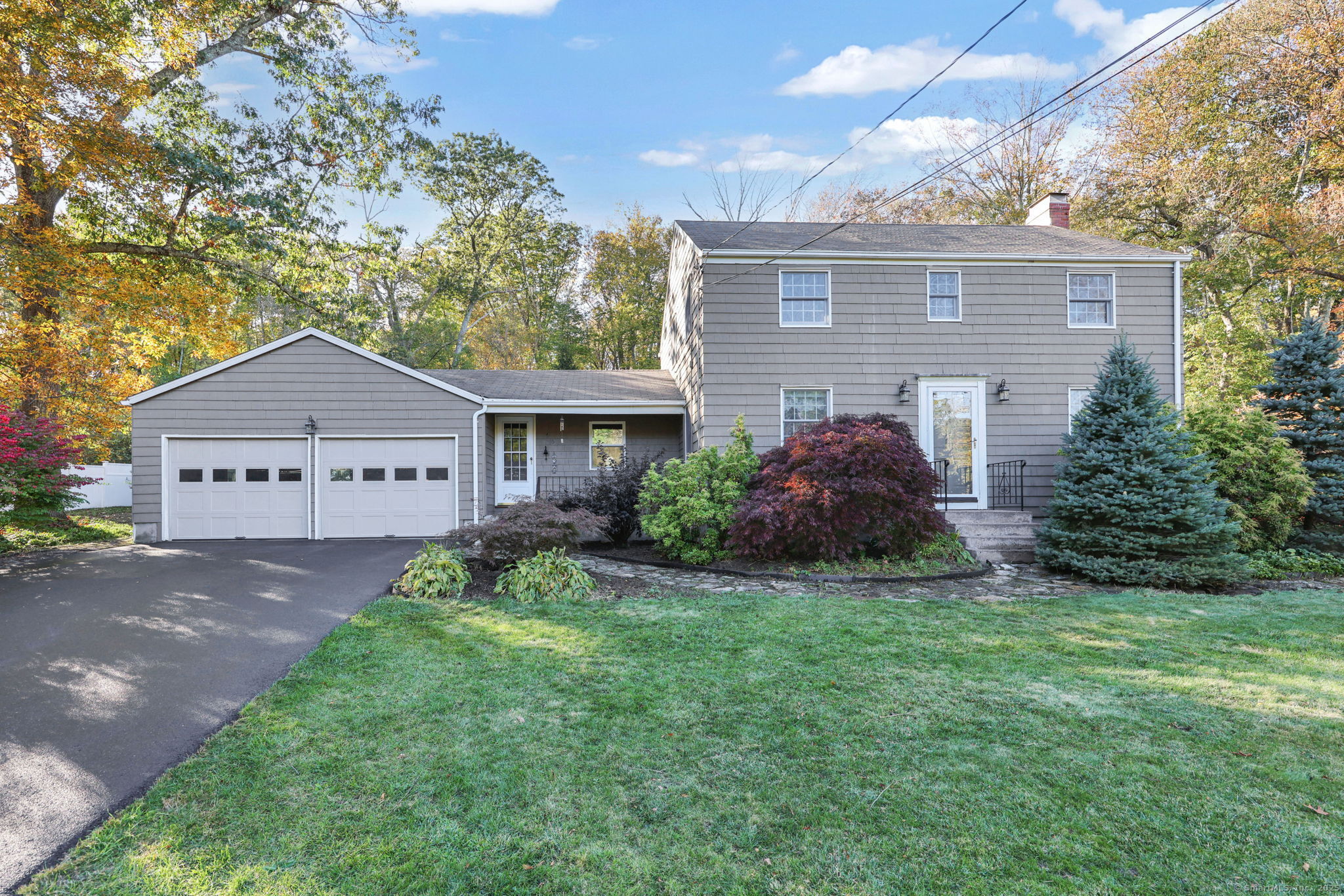 a front view of house with yard and green space