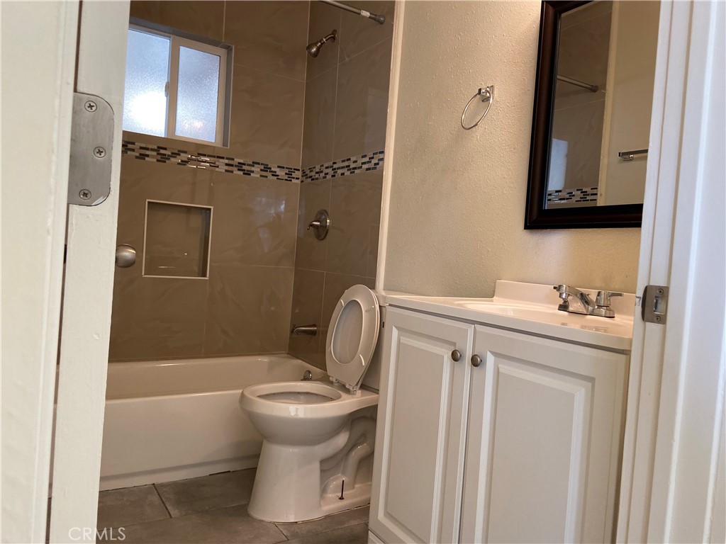 10952 Rose Street Stanton, CA 90680 - Photo 8 of 34 a bathroom with a sink toilet and shower