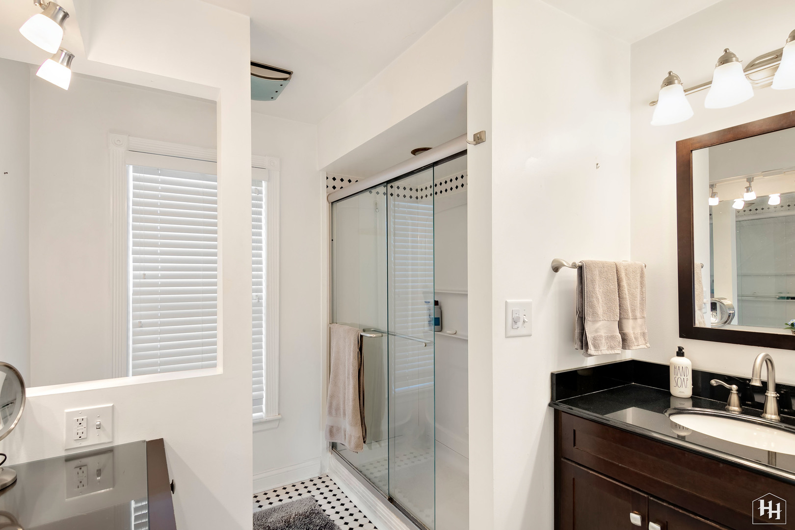 2761 Prairie Road Buffalo Grove, IL 60089 - Photo 14 of 23 a bathroom with a granite countertop sink a mirror and a shower