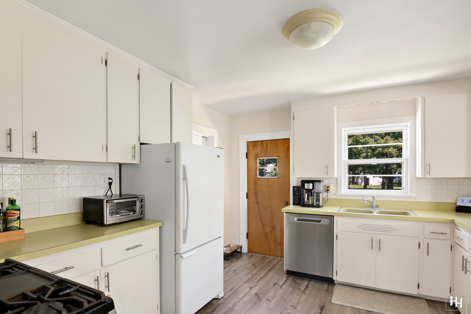 2761 Prairie Road Buffalo Grove, IL 60089 - Photo 3 of 23 a kitchen with white cabinets and white appliances