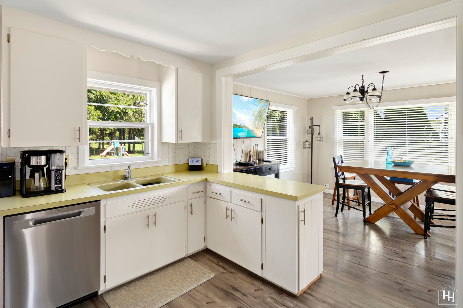 2761 Prairie Road Buffalo Grove, IL 60089 - Photo 4 of 23 a kitchen with a stove a sink a dining table and chairs