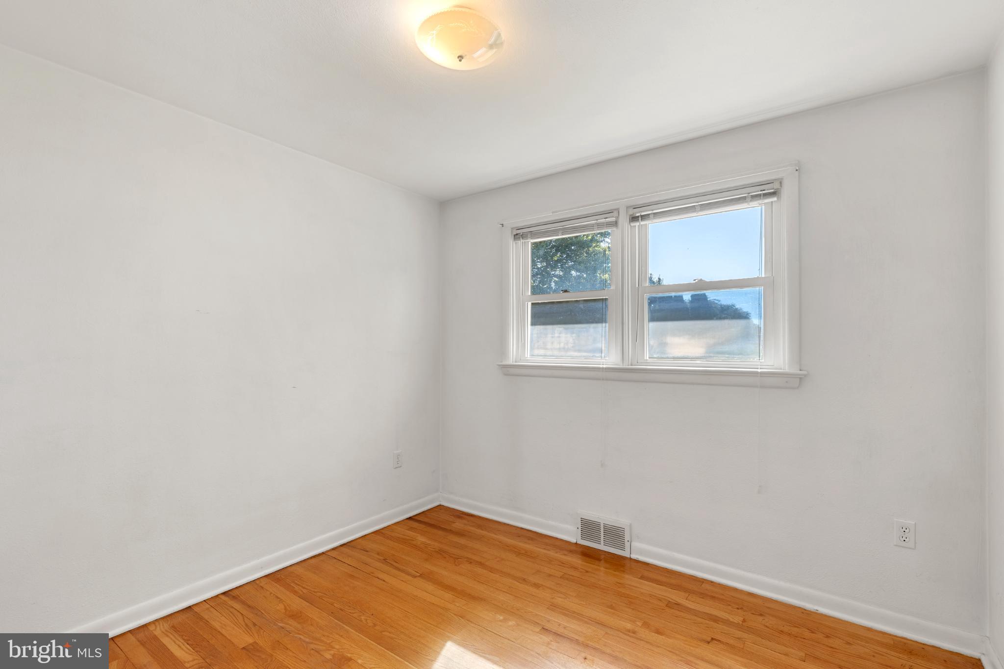 1640 Church Road York, PA 17408 - Photo 9 of 26 a view of an empty room with wooden floor and a window
