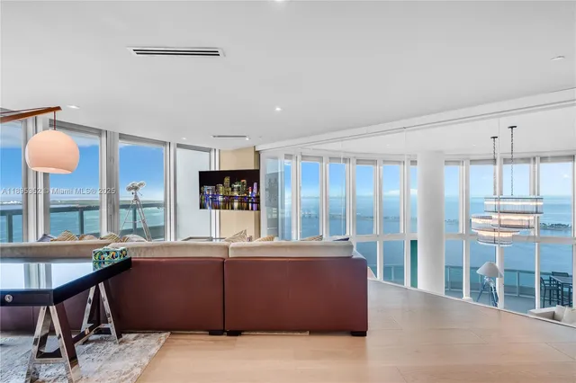 a kitchen with stainless steel appliances kitchen island granite countertop a stove a sink a refrigerator and cabinets