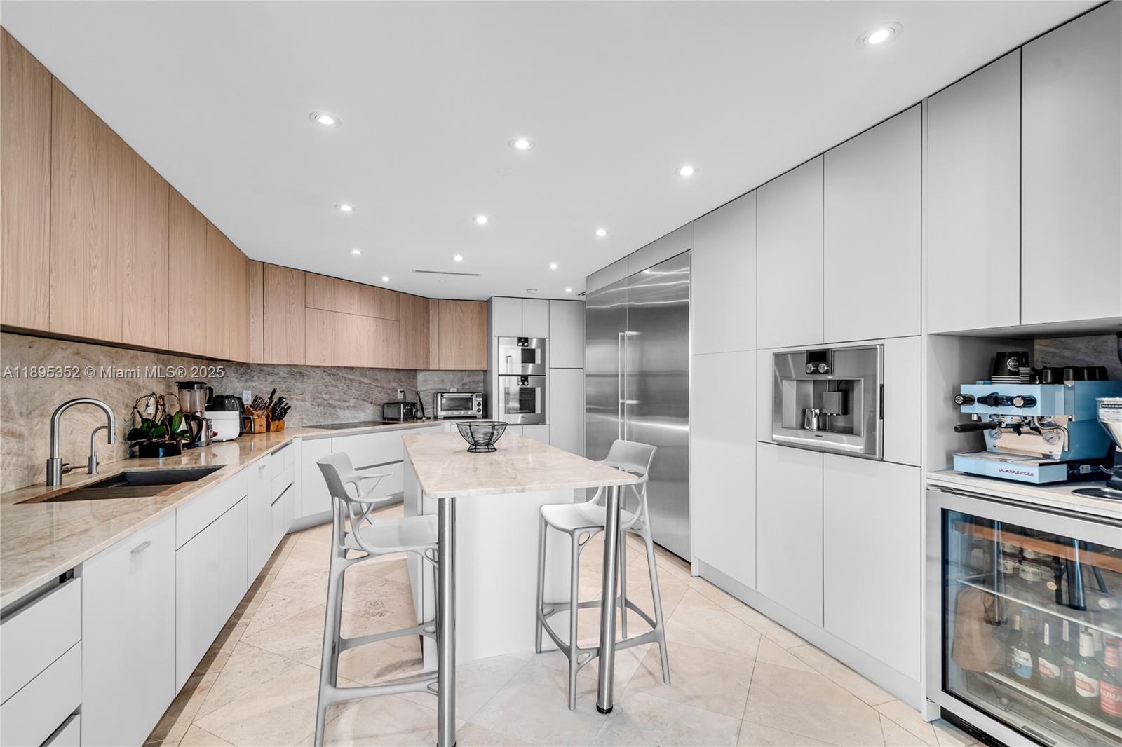 1643 Brickell Avenue, Unit 3501 Miami, FL 33129 - Photo 22 of 91 a kitchen with stainless steel appliances kitchen island granite countertop a stove a sink a refrigerator and cabinets