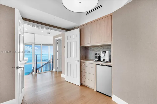 a spacious bathroom with a double vanity sink toilet mirror and bathtub
