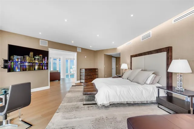 a bedroom with two beds and a bookshelf