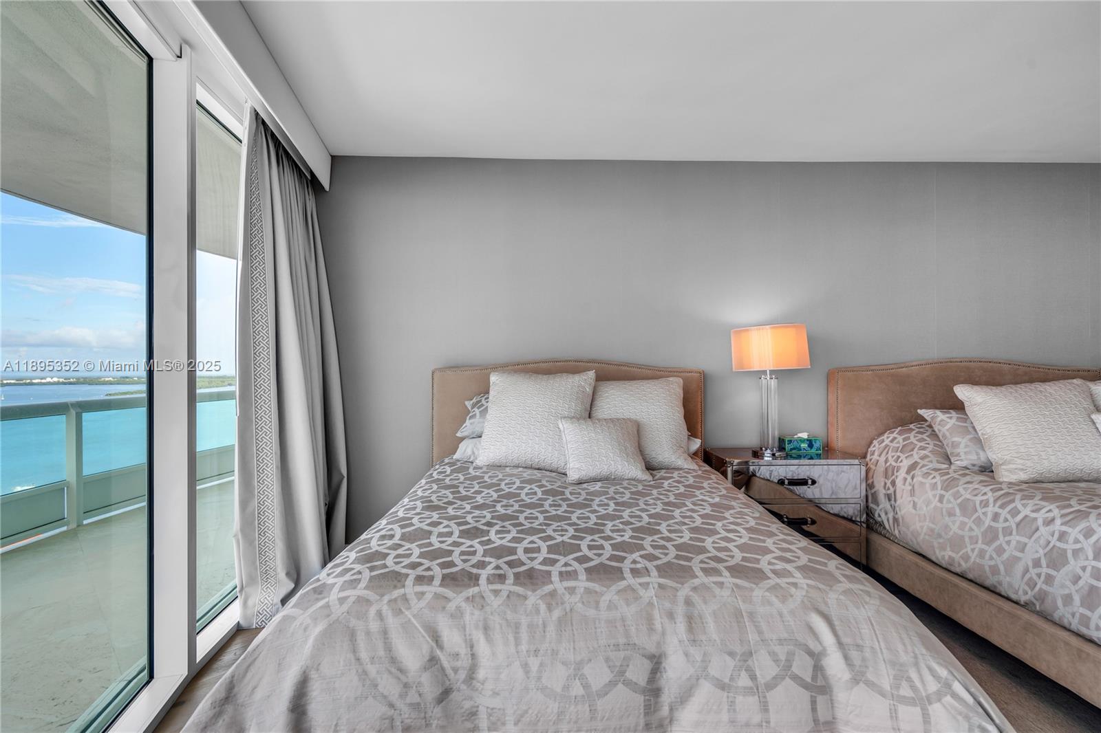 1643 Brickell Avenue, Unit 3501 Miami, FL 33129 - Photo 39 of 91 a bedroom with a bed and a night stand