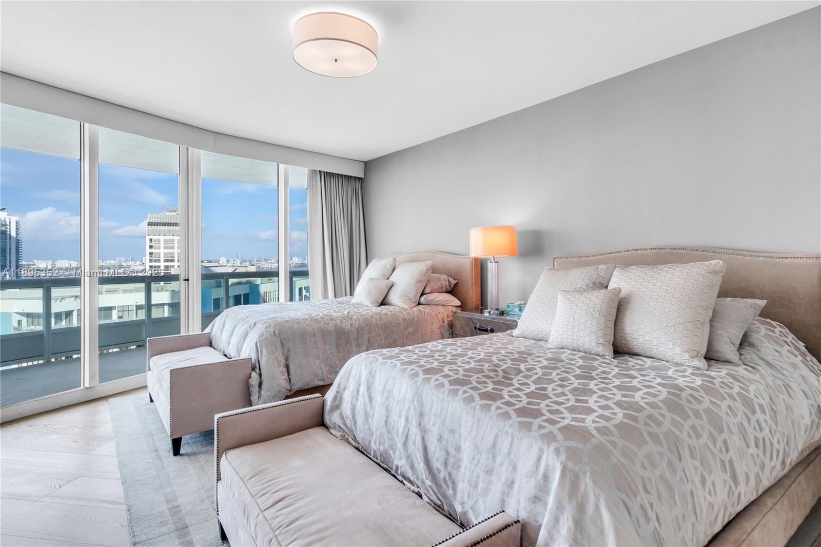 1643 Brickell Avenue, Unit 3501 Miami, FL 33129 - Photo 40 of 91 a bed room with two bed and a large window