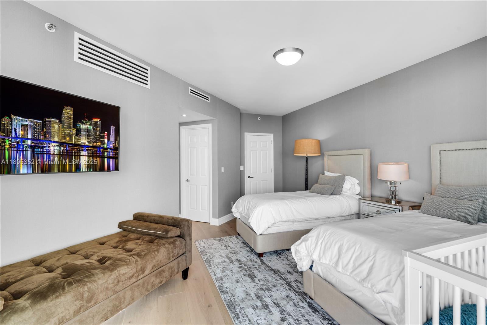 1643 Brickell Avenue, Unit 3501 Miami, FL 33129 - Photo 43 of 91 a bedroom with two beds and a bookshelf