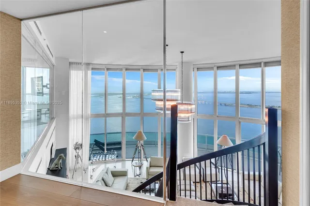 a living room with furniture and large mirror