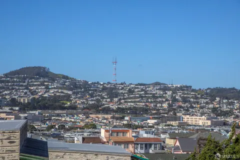 a bedroom with a large bed and a painting on the wall