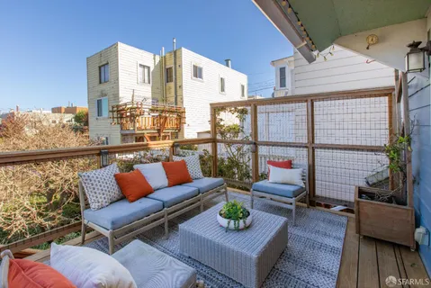 a view of a room that has a table and a chair in it