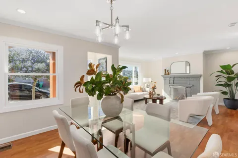 a living room with furniture potted plant and a fireplace