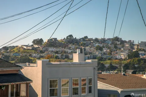 a living room with furniture a fireplace and a large window
