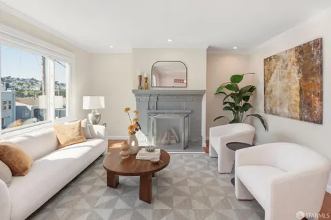 a dining room with furniture potted plants and wooden floor