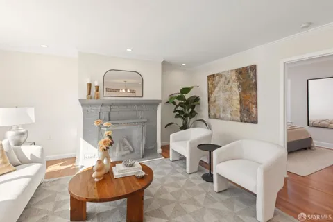 a dining room with furniture a chandelier and wooden floor