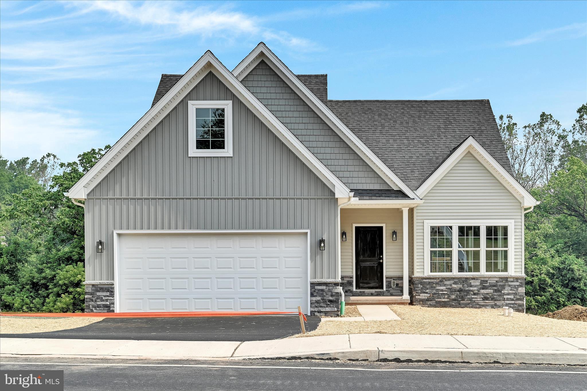 a view of a house with a yard and garage