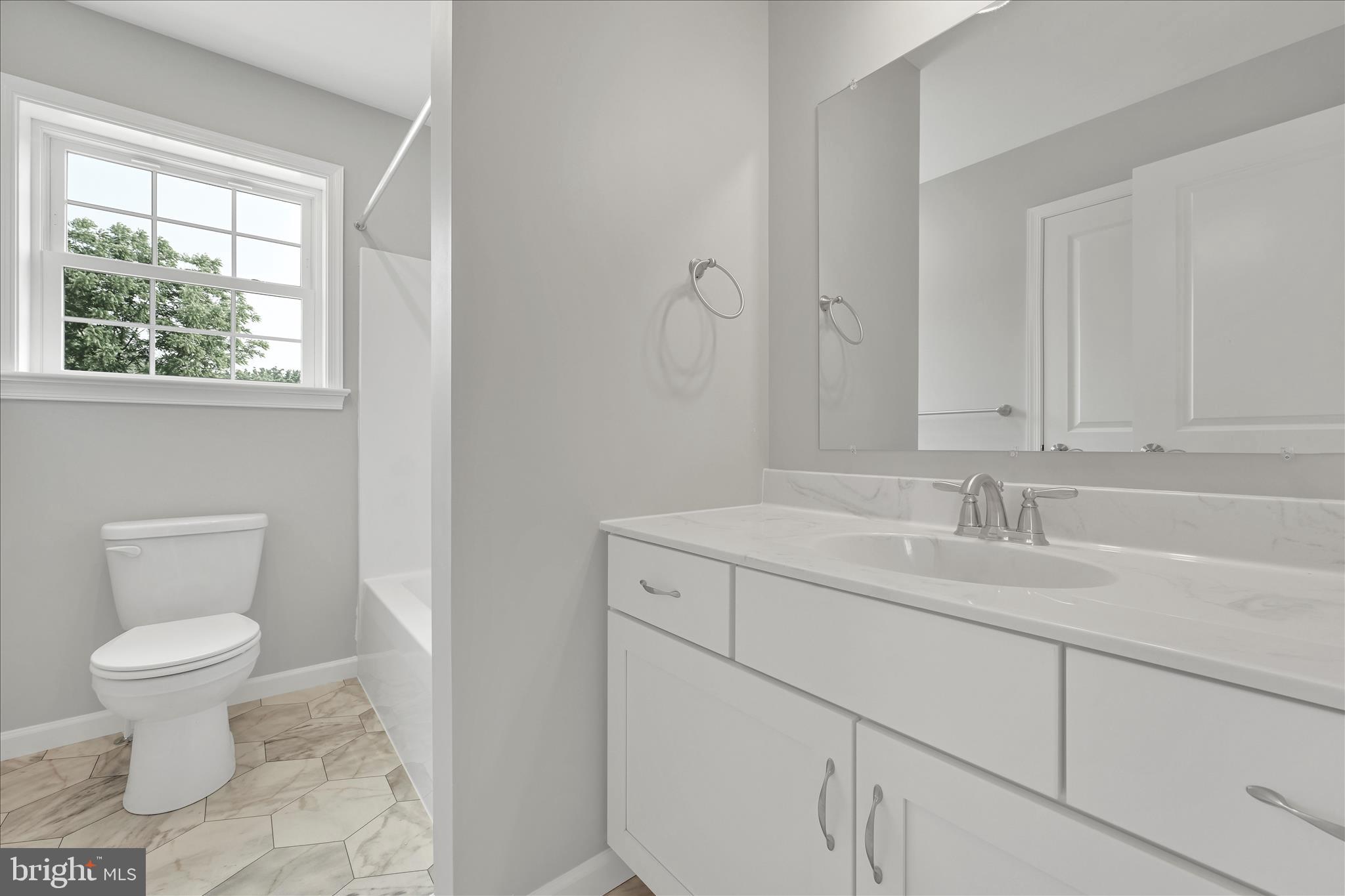 227 Pilgrim Drive Lancaster, PA 17603 - Photo 17 of 24 a bathroom with a granite countertop sink a toilet and a window