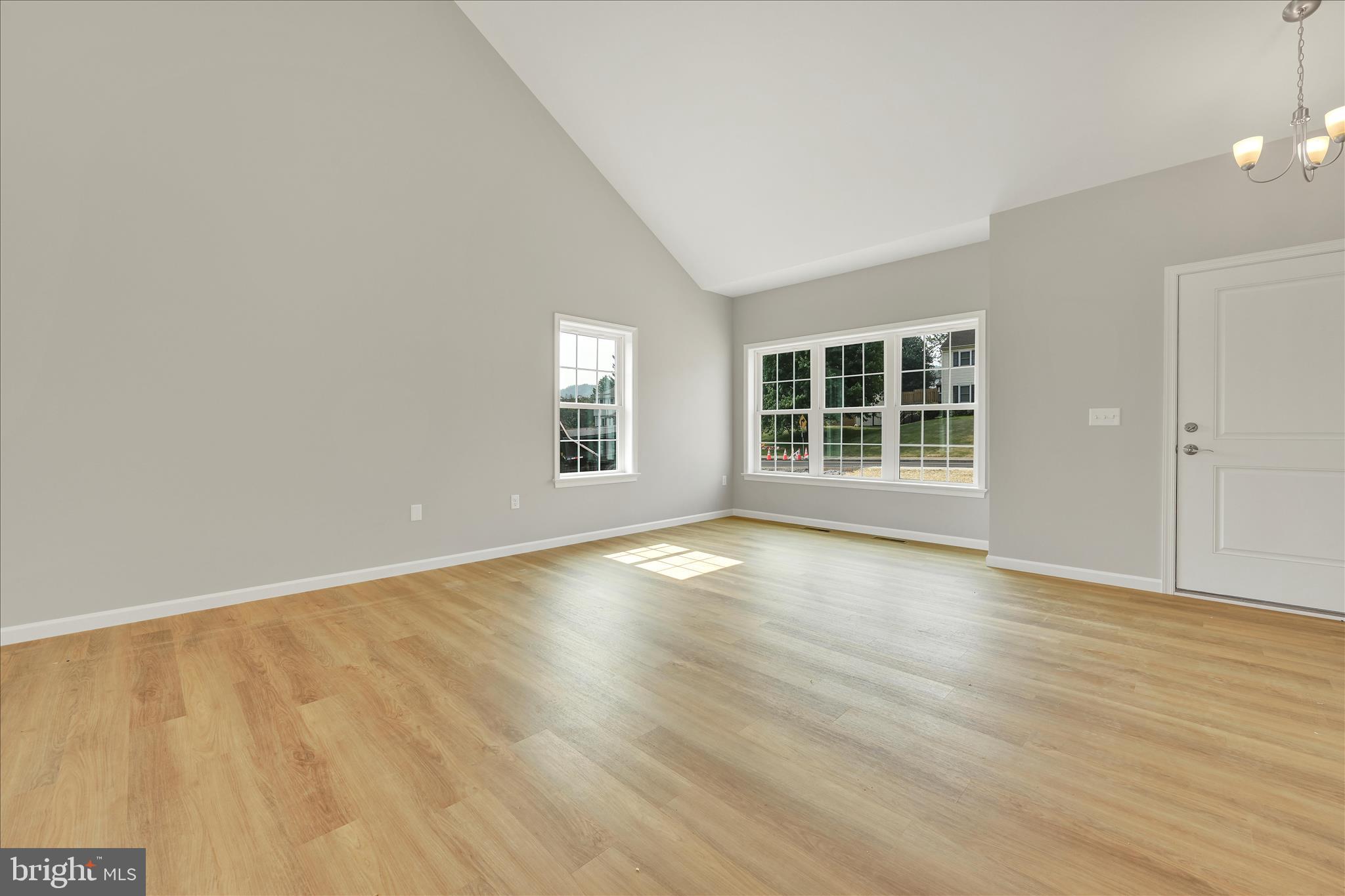 227 Pilgrim Drive Lancaster, PA 17603 - Photo 3 of 24 an empty room with wooden floor and windows