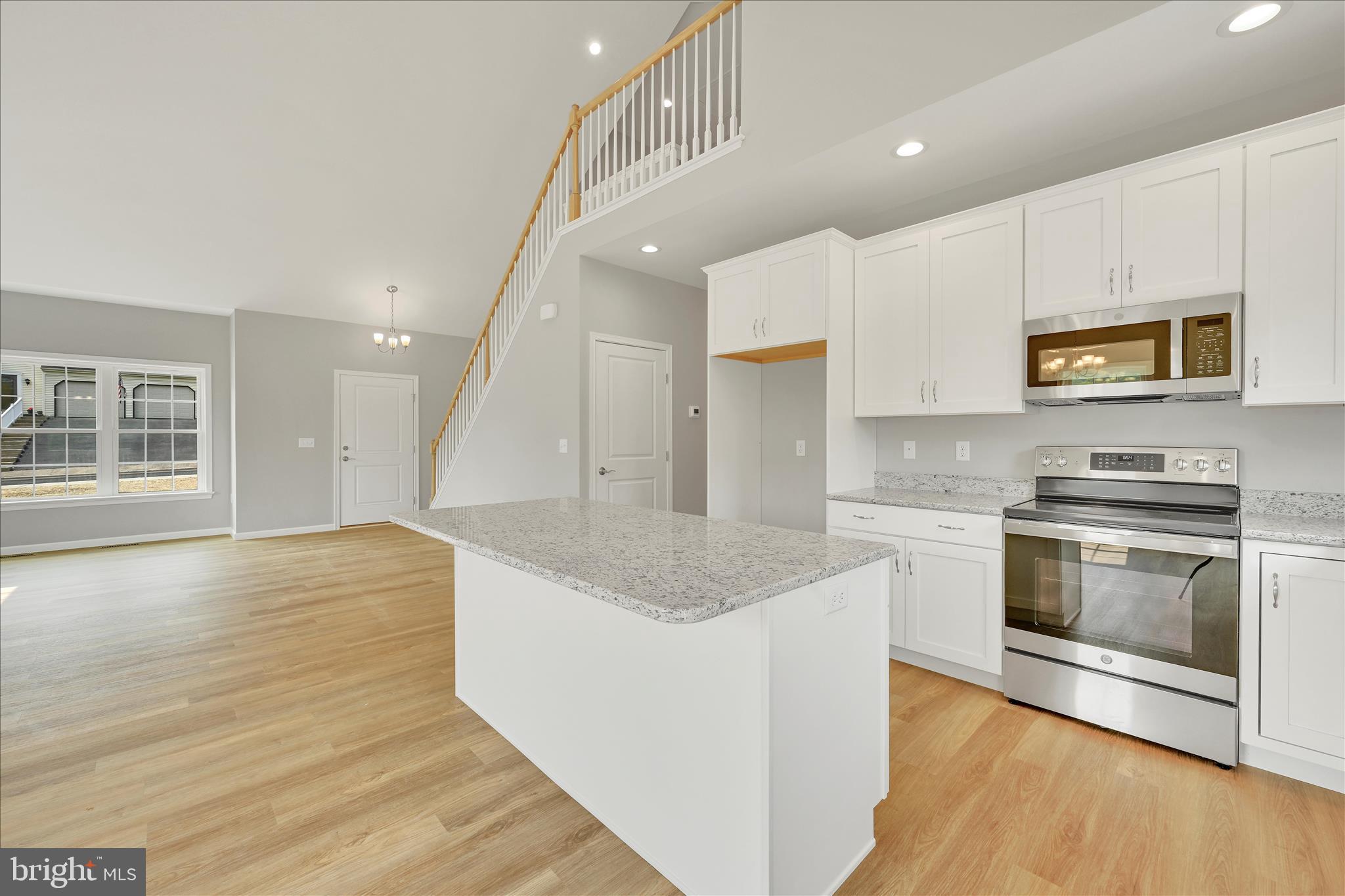 227 Pilgrim Drive Lancaster, PA 17603 - Photo 9 of 24 a kitchen with stainless steel appliances granite countertop a sink a stove and a wooden floors