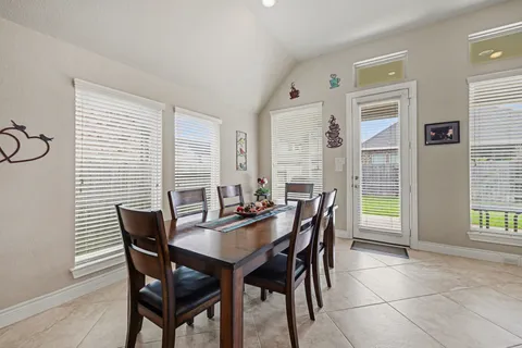 a dining room with furniture and window
