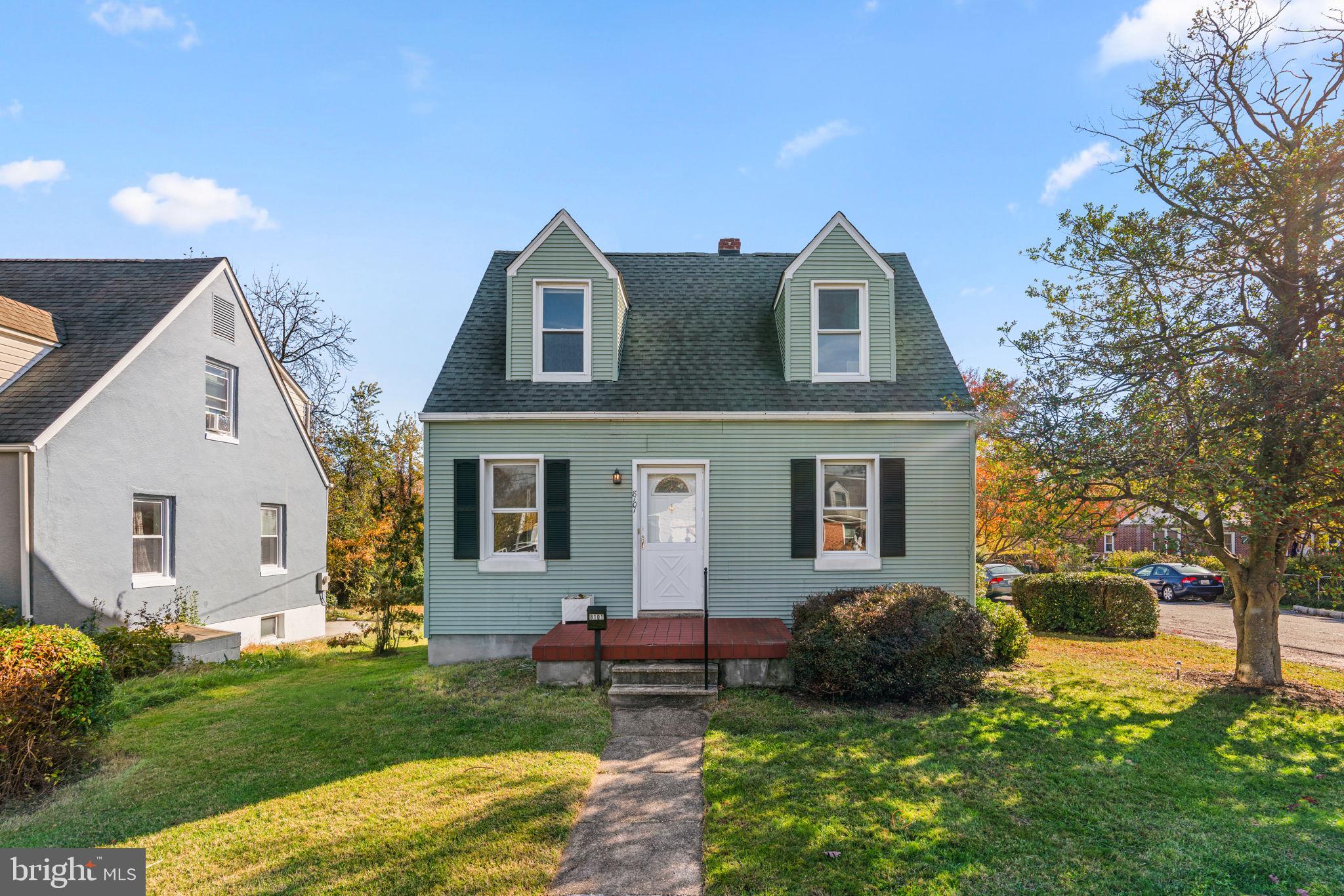 a front view of house with yard and green space