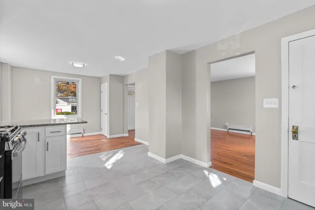 a view of livingroom with kitchen and hardwood