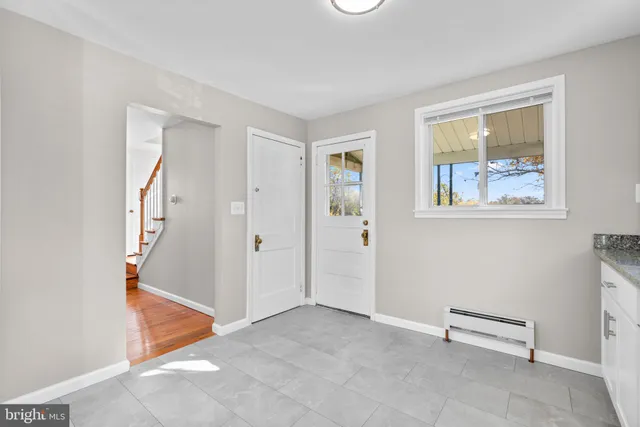 an empty room with windows and closet