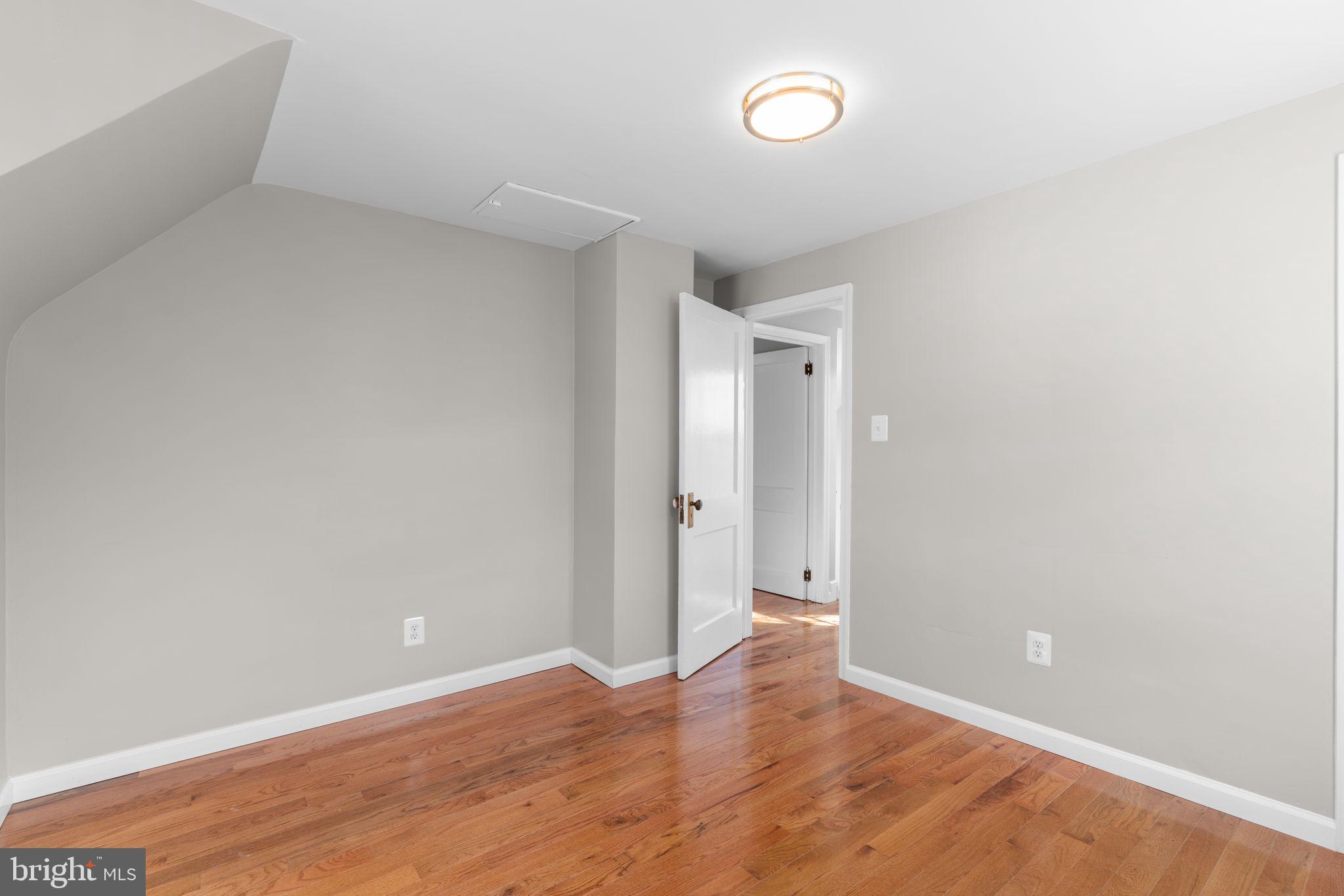 8101 Hillendale Road Baltimore, MD 21234 - Photo 19 of 27 a view of an empty room with wooden floor and a window