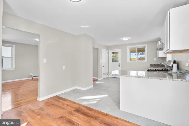 a view of a kitchen with a sink microwave and cabinets