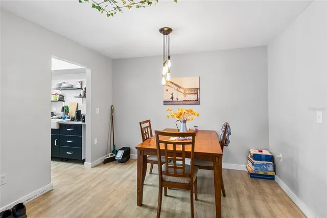 a dining room with furniture and wooden floor