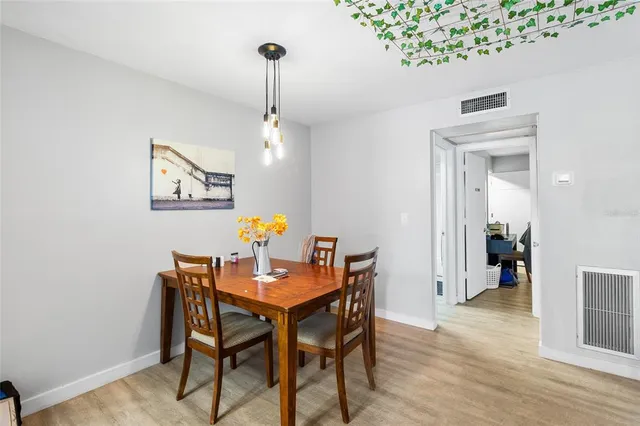 a view of a dining room with a table and chairs