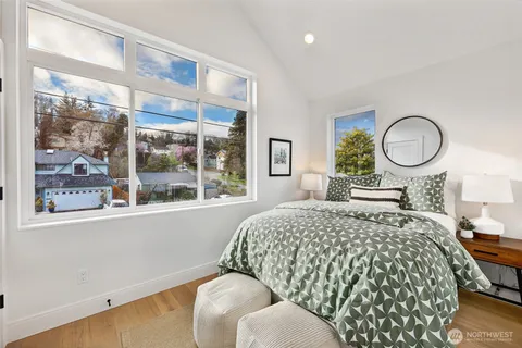 a bedroom with a large bed and a large window