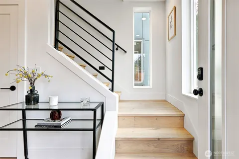 a view of entryway and hall with wooden floor