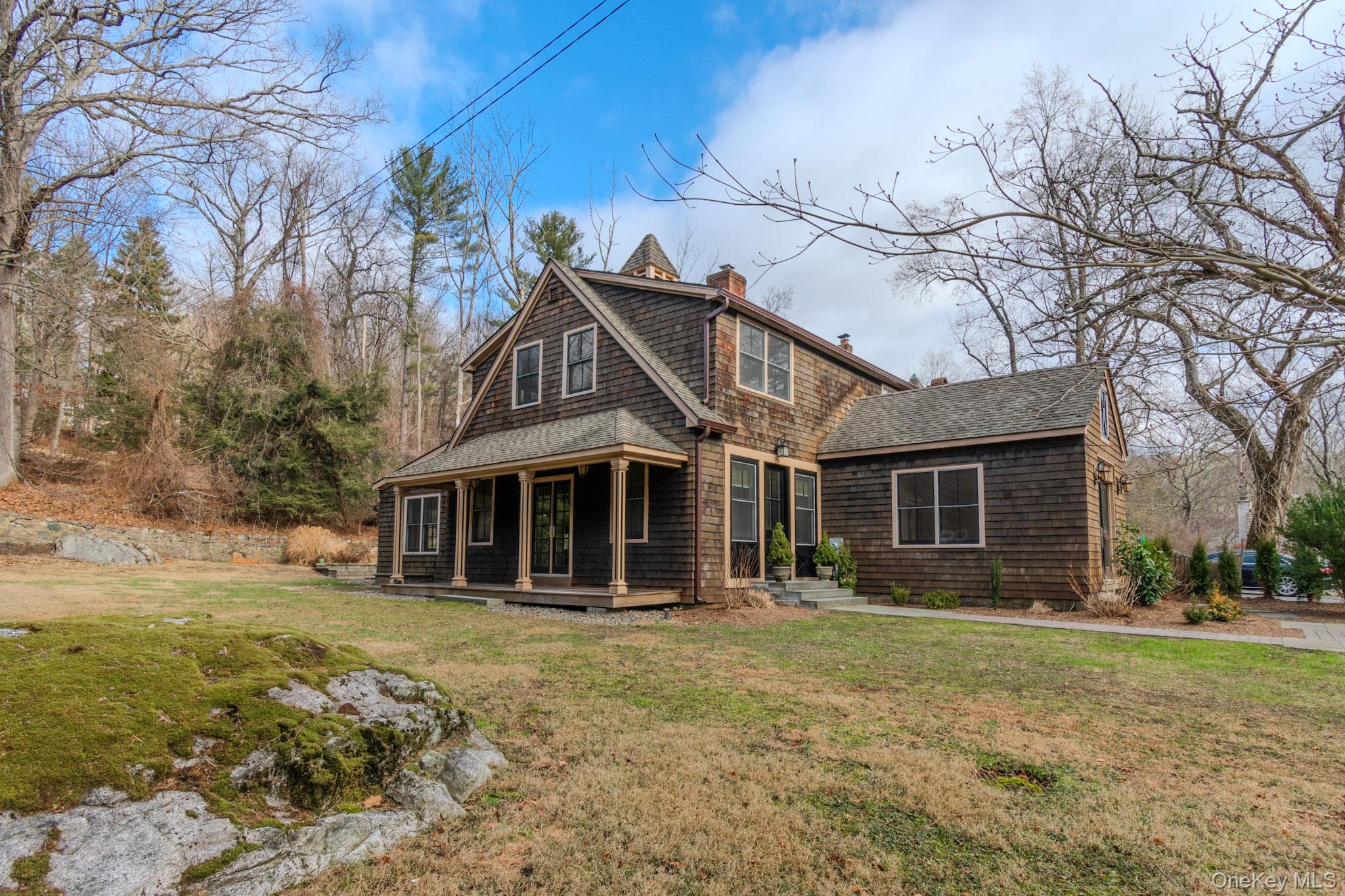 Rear view of house with a yard
