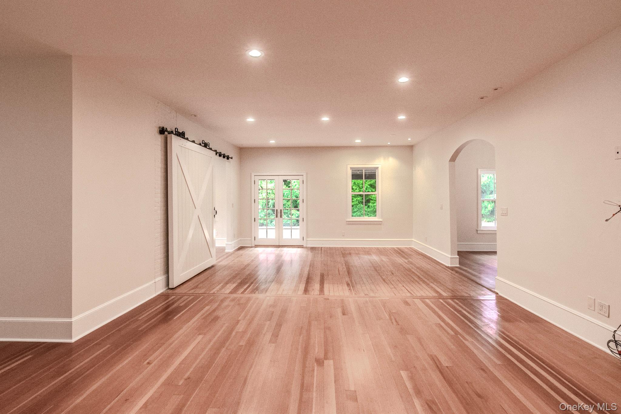 54 East Lake Stable Road Tuxedo Park, NY 10987 - Photo 13 of 31 Spare room with plenty of natural light, french doors, and light wood-type flooring