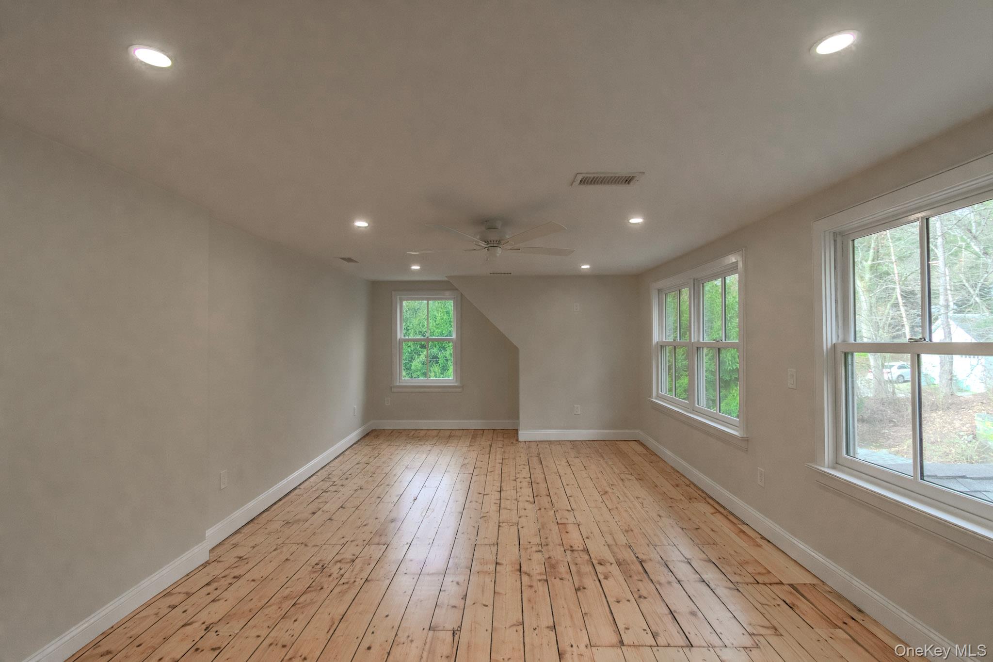 54 East Lake Stable Road Tuxedo Park, NY 10987 - Photo 21 of 31 Empty room with light wood-type flooring and ceiling fan