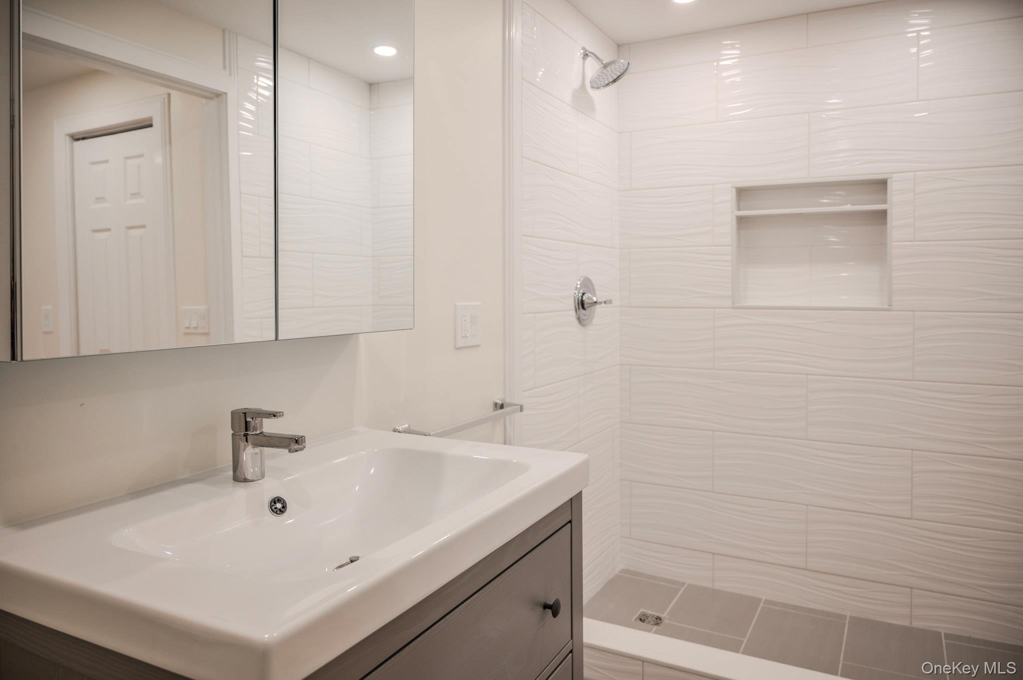 54 East Lake Stable Road Tuxedo Park, NY 10987 - Photo 22 of 31 Bathroom with a tile shower and vanity