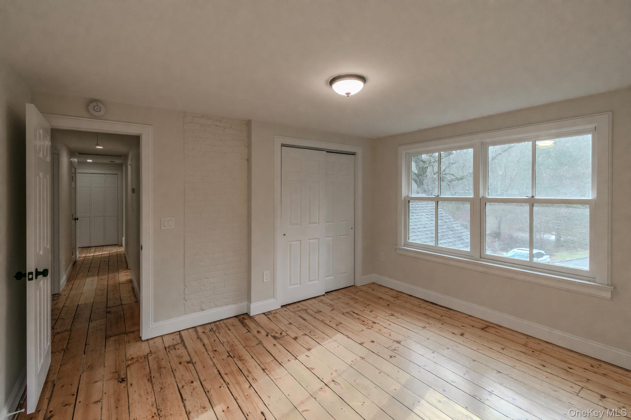 54 East Lake Stable Road Tuxedo Park, NY 10987 - Photo 26 of 31 Unfurnished bedroom featuring light hardwood / wood-style floors and a closet