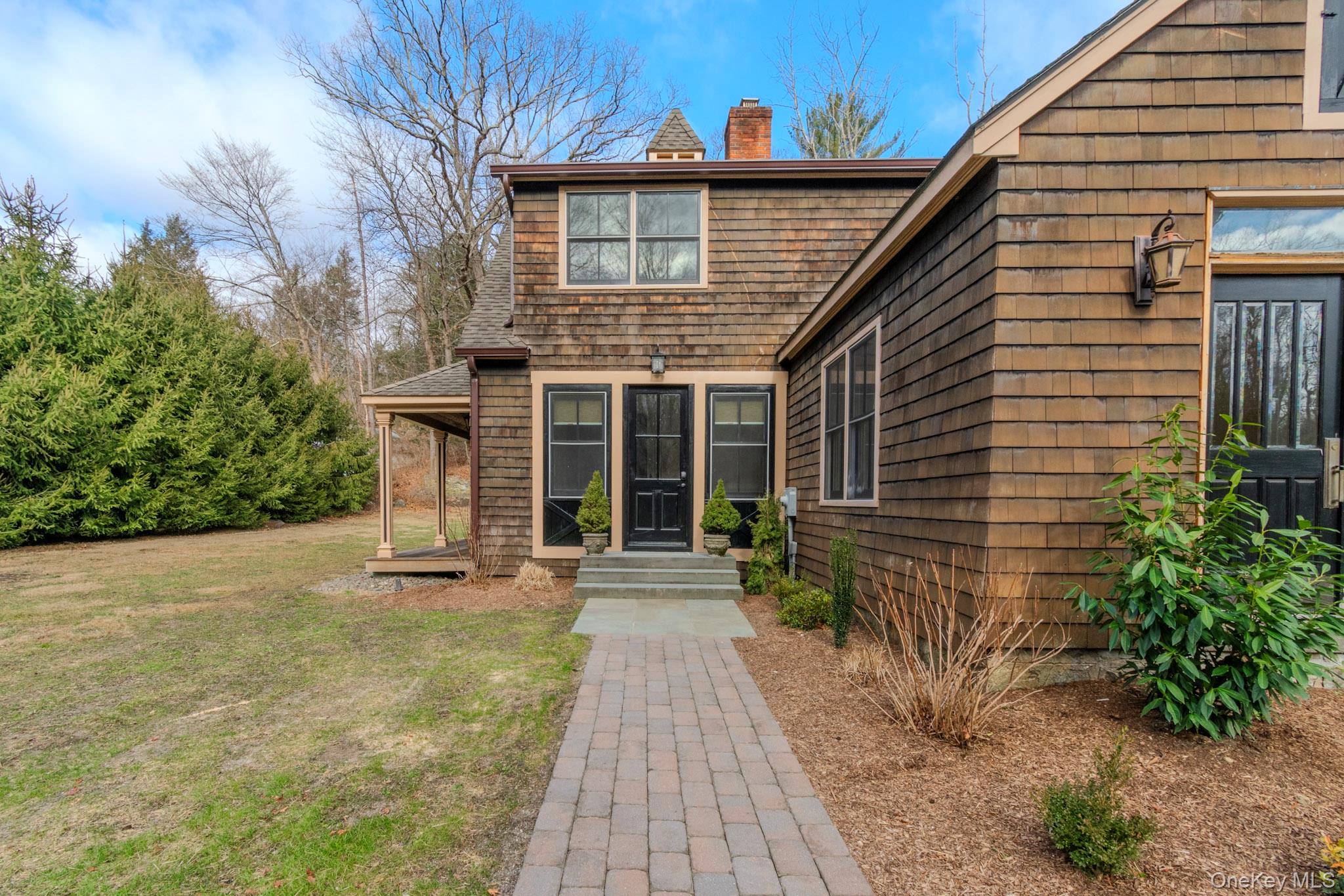54 East Lake Stable Road Tuxedo Park, NY 10987 - Photo 4 of 31 Doorway to property with a lawn