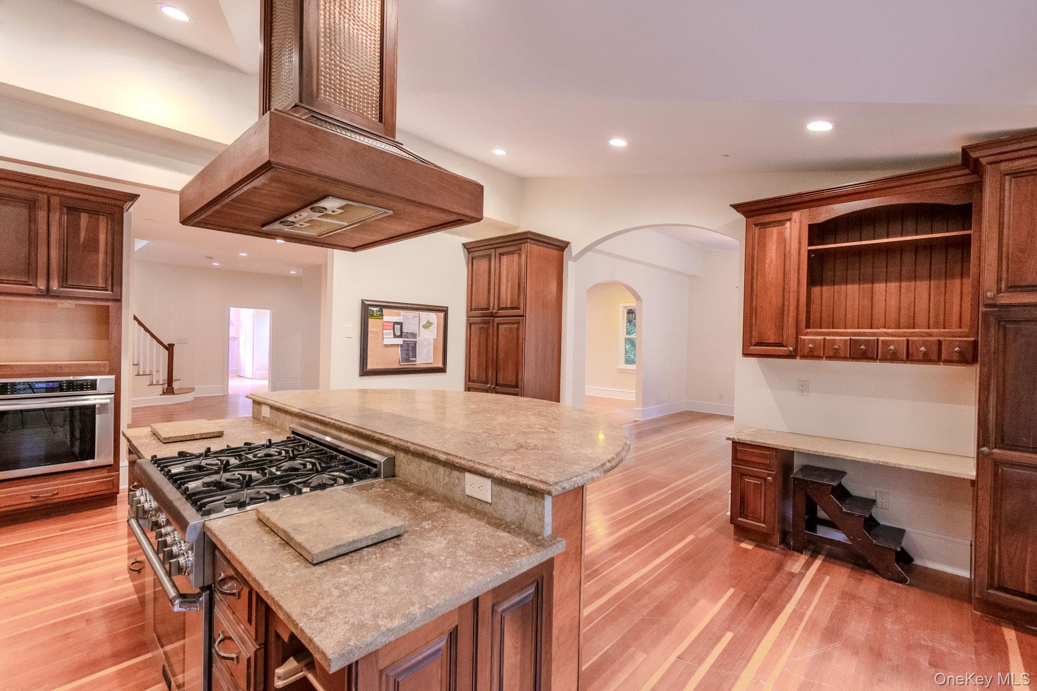 54 East Lake Stable Road Tuxedo Park, NY 10987 - Photo 6 of 31 Kitchen with a kitchen island, stainless steel appliances, custom range hood, and light hardwood / wood-style floors