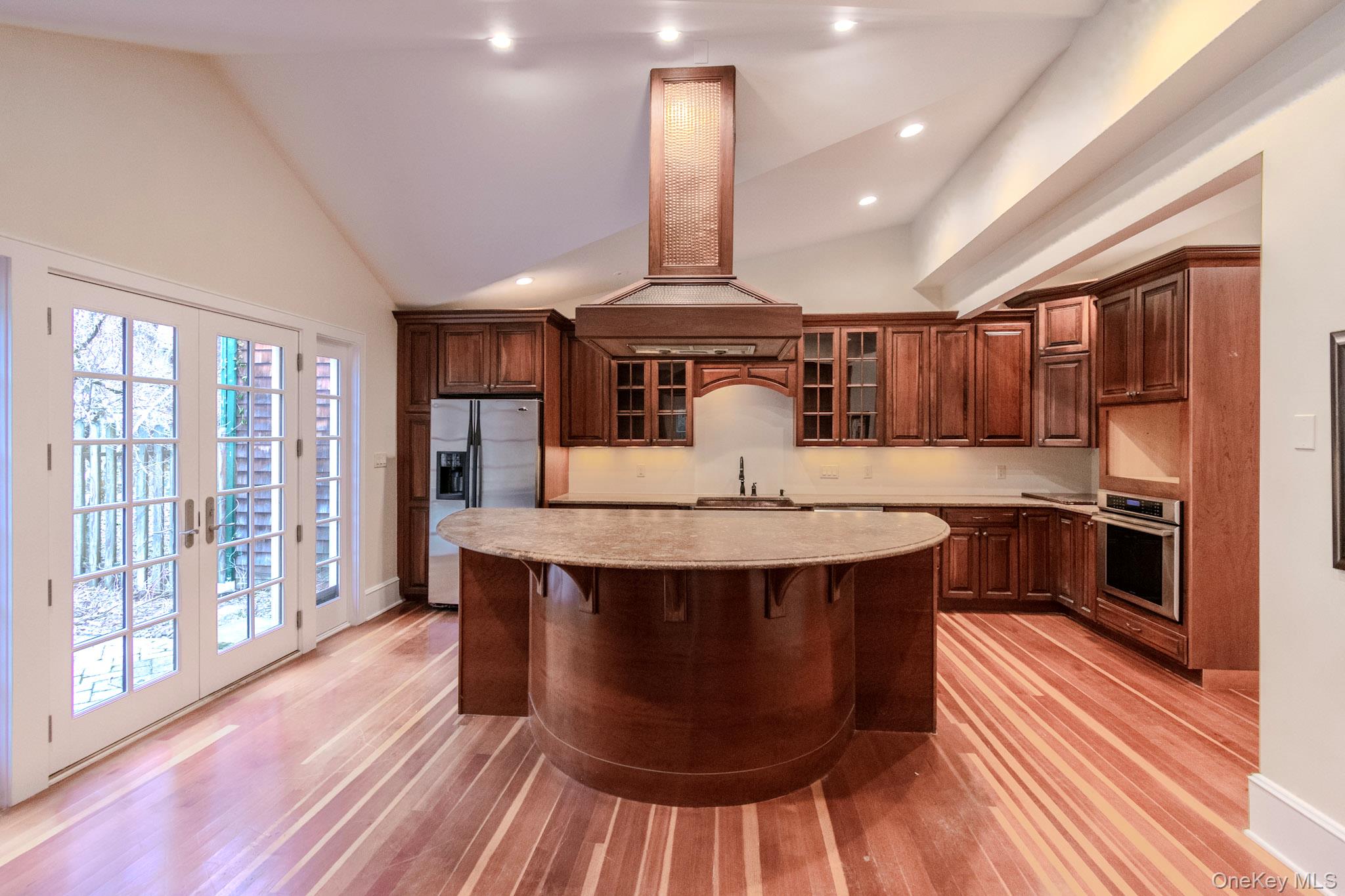 54 East Lake Stable Road Tuxedo Park, NY 10987 - Photo 7 of 31 Kitchen featuring island exhaust hood, french doors, stainless steel appliances, high vaulted ceiling, and a center island