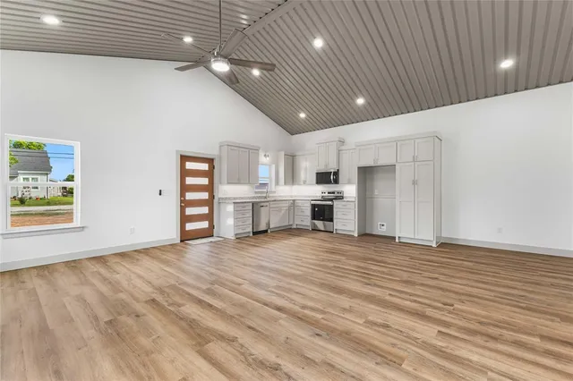 a view of kitchen appliances wooden floor and electronic appliances