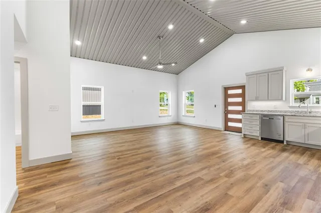 a view of an empty room with a kitchen