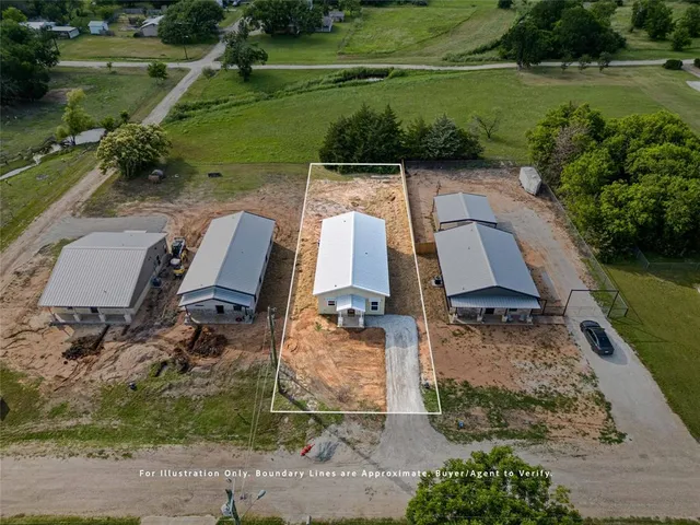 an aerial view of a house with outdoor space lake view and a yard