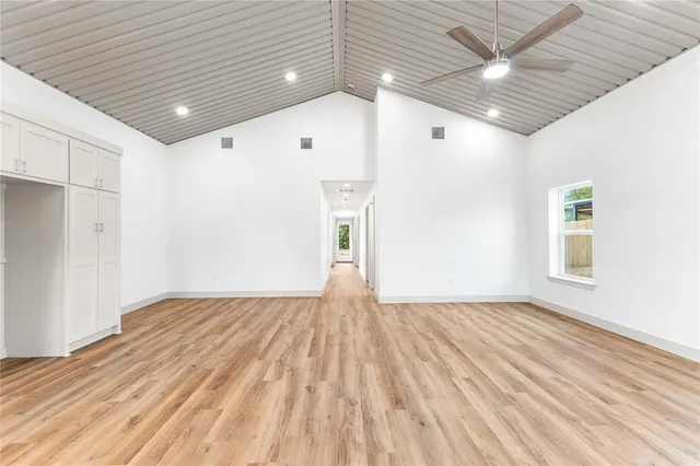 a view of empty room with wooden floor