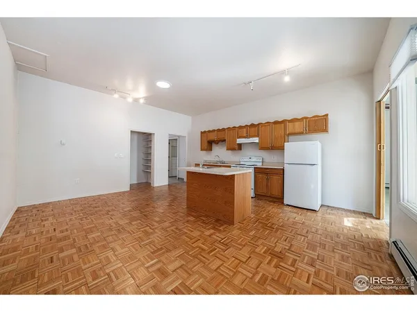 a view of kitchen with refrigerator sink and cabinets