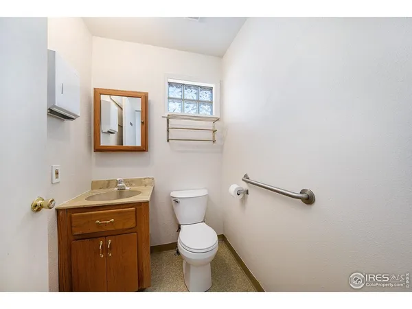 a bathroom with a toilet a sink and mirror