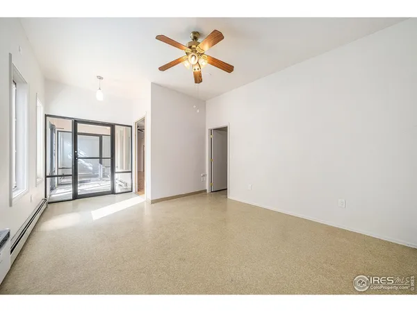 a view of an empty room with a ceiling fan
