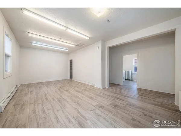 a view of an empty room and wooden floor